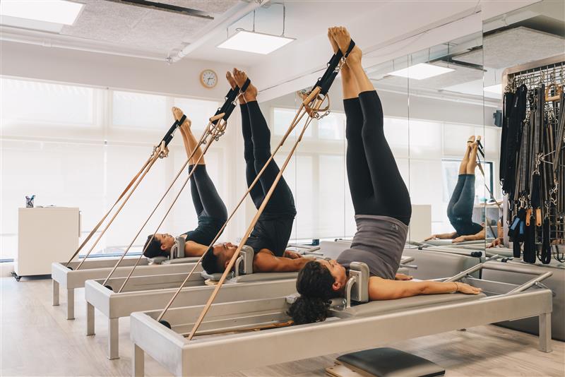 Individuals exercising on Universal Reformer