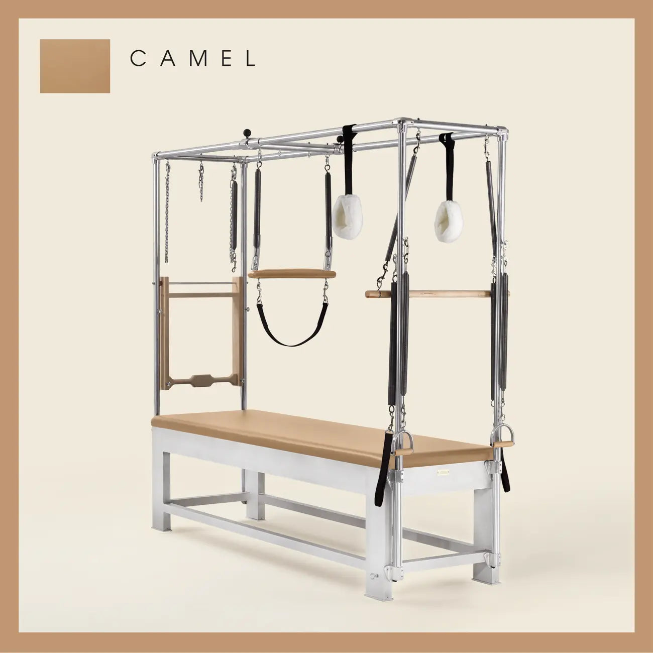Camel color Trapeze Table with aluminum frame, adjustable bars, straps, and springs. Premium Pilates equipment against a beige background.