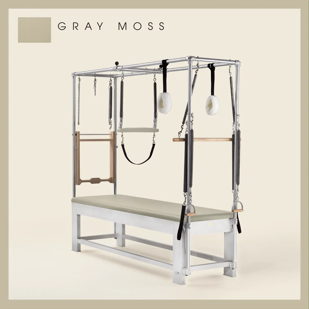 Gray moss color Trapeze Table with aluminum frame, adjustable bars, straps, and springs. Premium Pilates equipment against a beige background.