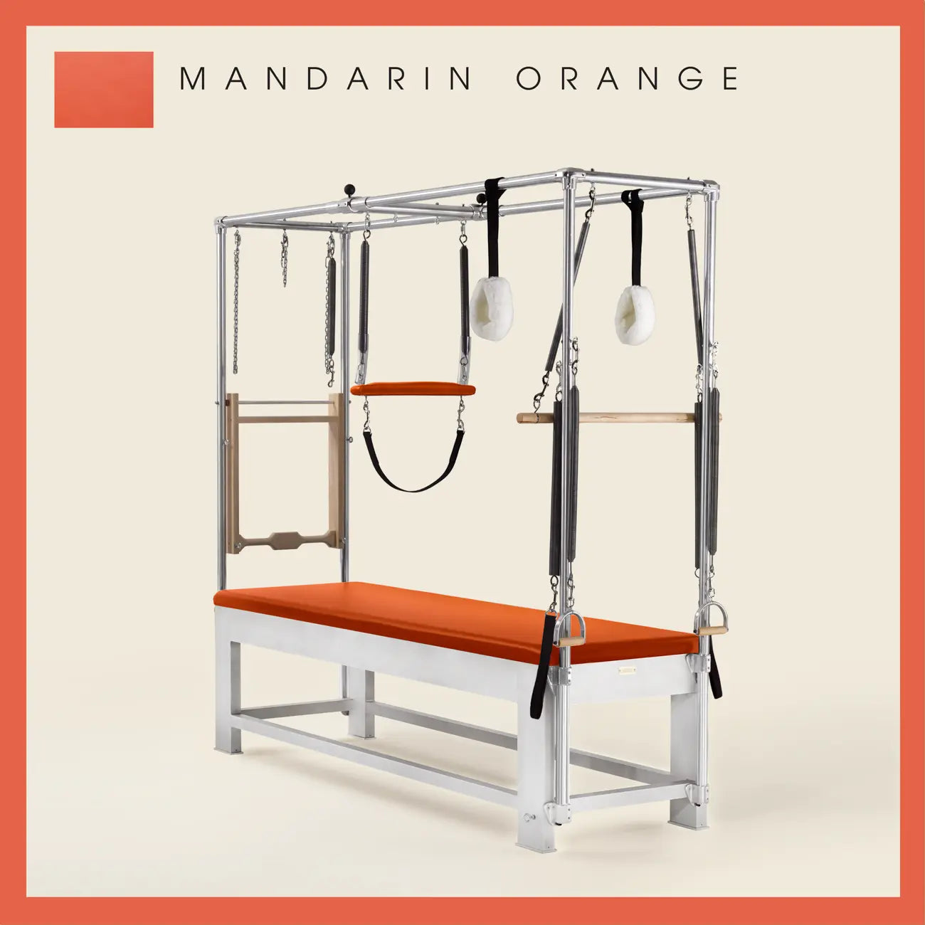 Mandarin Orange color Trapeze Table with aluminum frame, adjustable bars, straps, and springs. Premium Pilates equipment against a beige background.