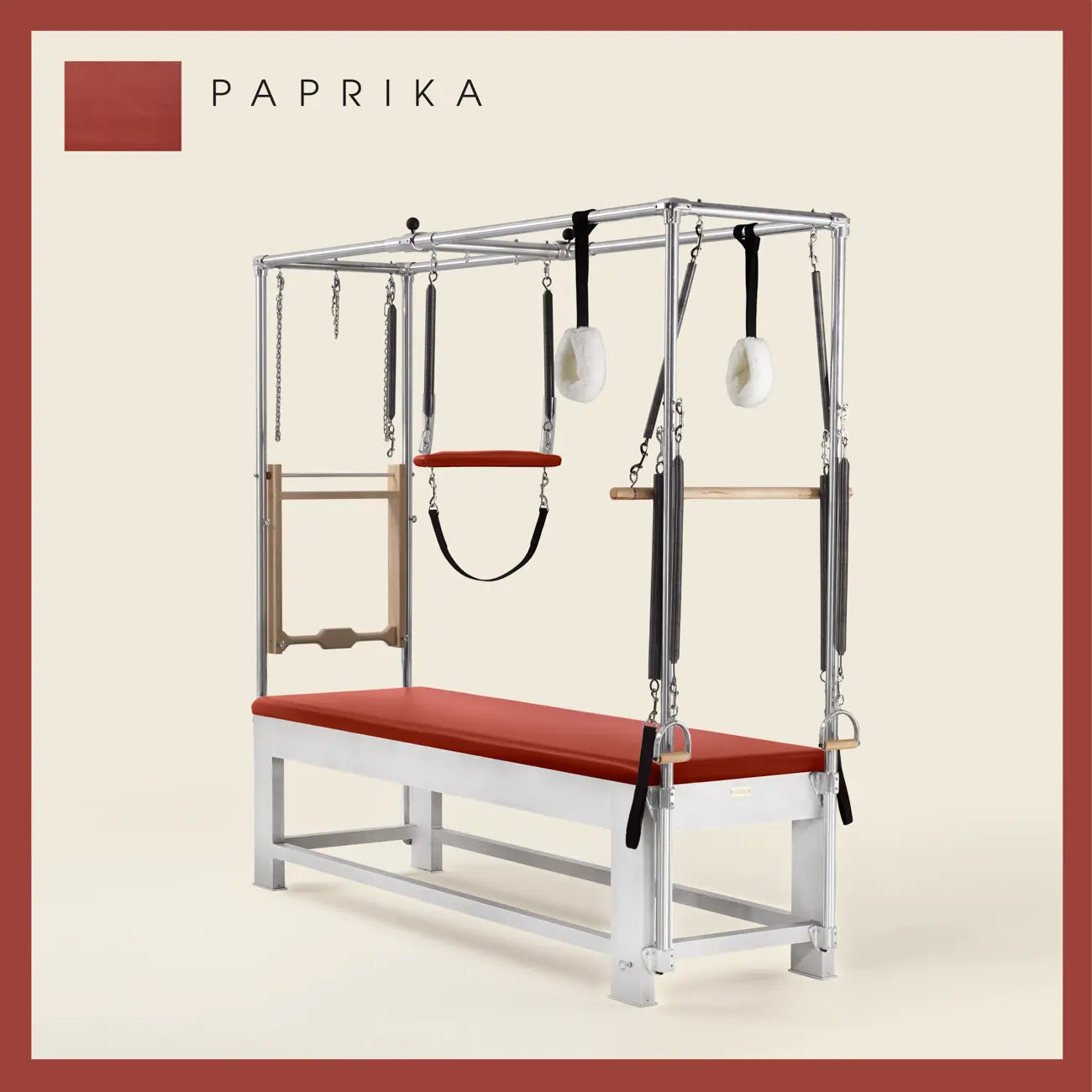Paprika color Trapeze Table with aluminum frame, adjustable bars, straps, and springs. Premium Pilates equipment against a beige background.