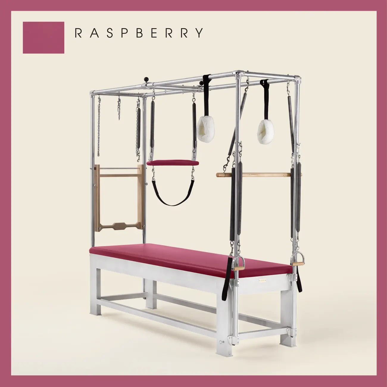 Raspberry color Trapeze Table with aluminum frame, adjustable bars, straps, and springs. Premium Pilates equipment against a beige background.