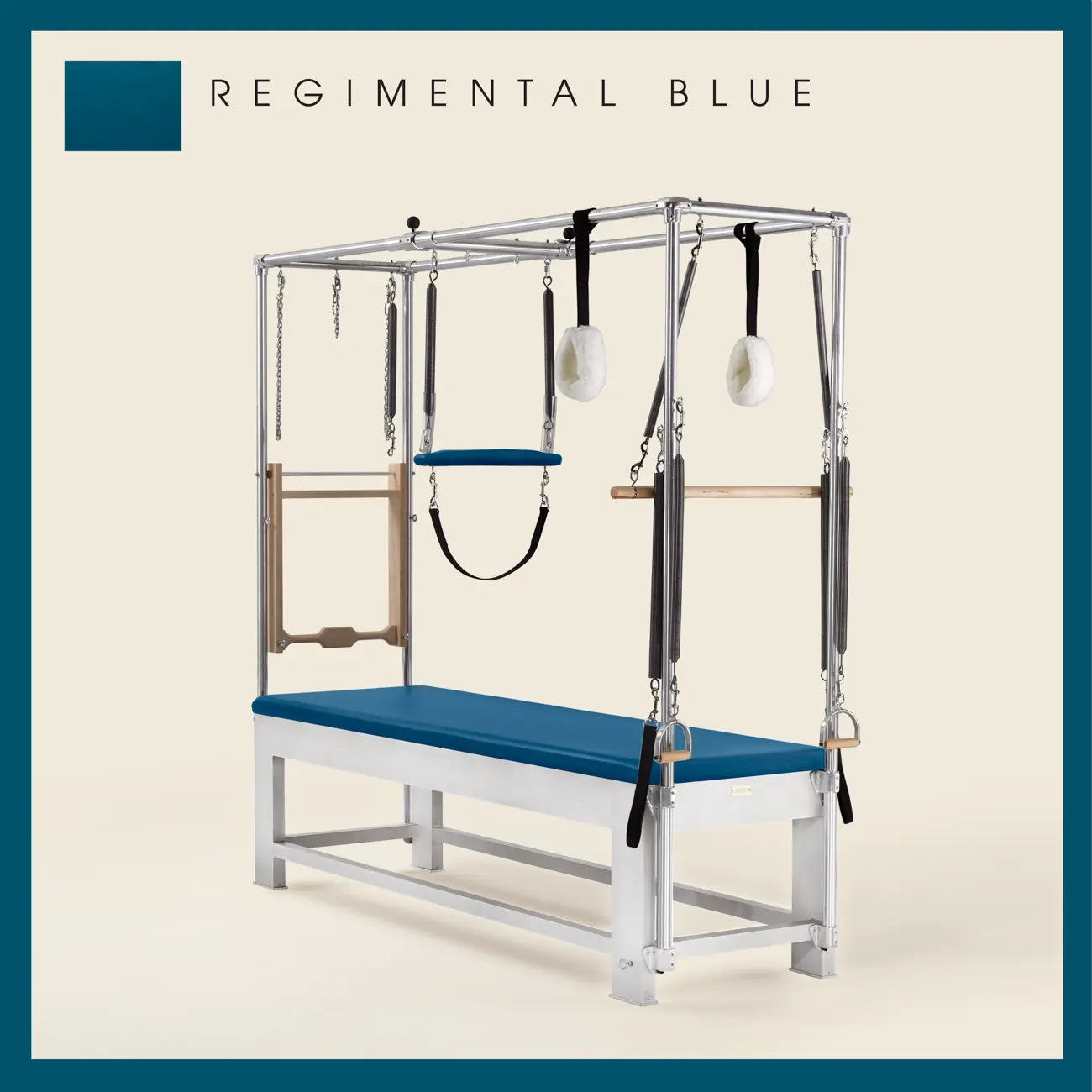 Regimental Blue color Trapeze Table with aluminum frame, adjustable bars, straps, and springs. Premium Pilates equipment against a beige background.