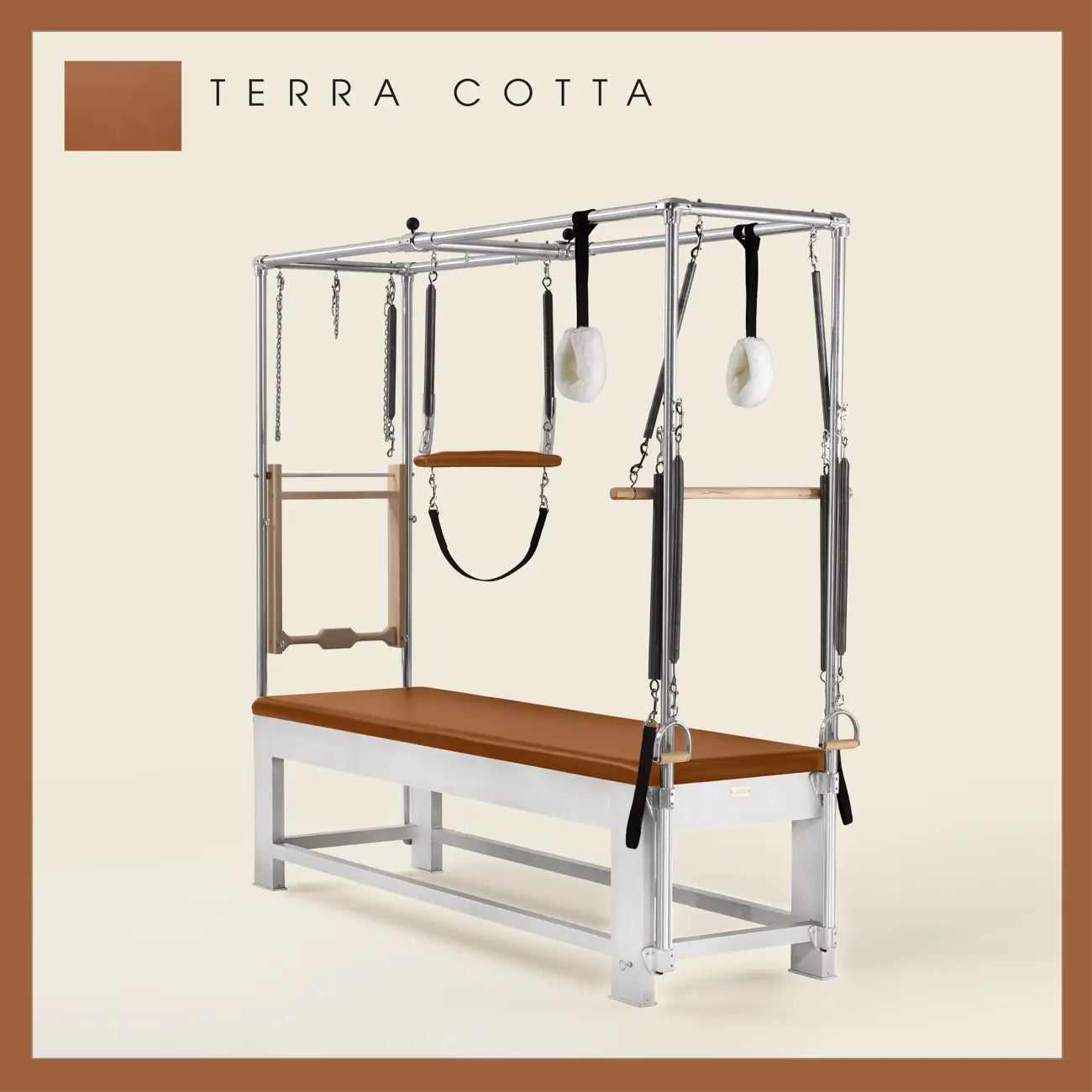 Terra Cotta color Trapeze Table with aluminum frame, adjustable bars, straps, and springs. Premium Pilates equipment against a beige background.