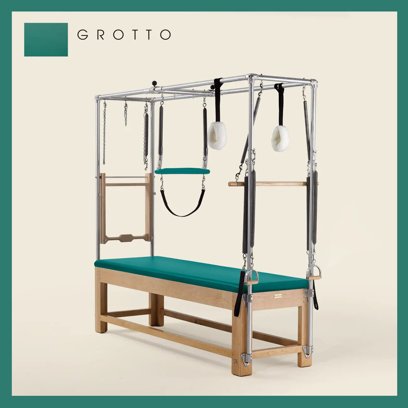 Grotto Pilates Cadillac with maple wood frame, adjustable bars, straps, and springs. Premium Pilates equipment against a beige background.
