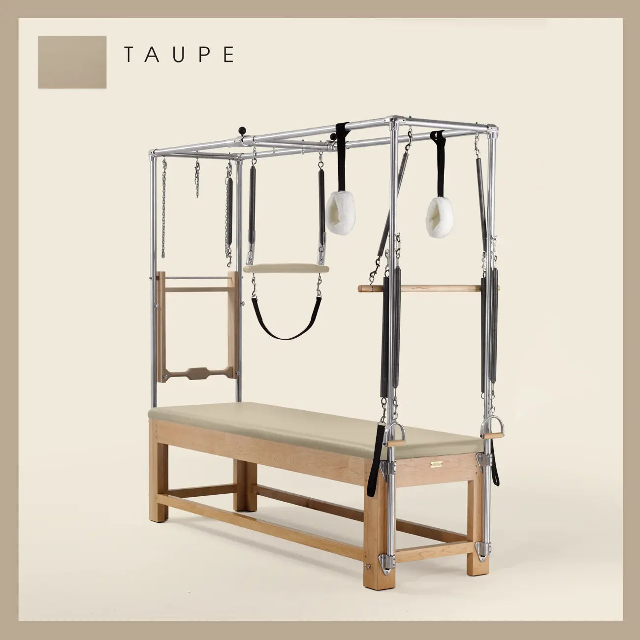 Taupe color Pilates Cadillac with maple wood frame, adjustable bars, straps, and springs. Premium Pilates equipment against a beige background.