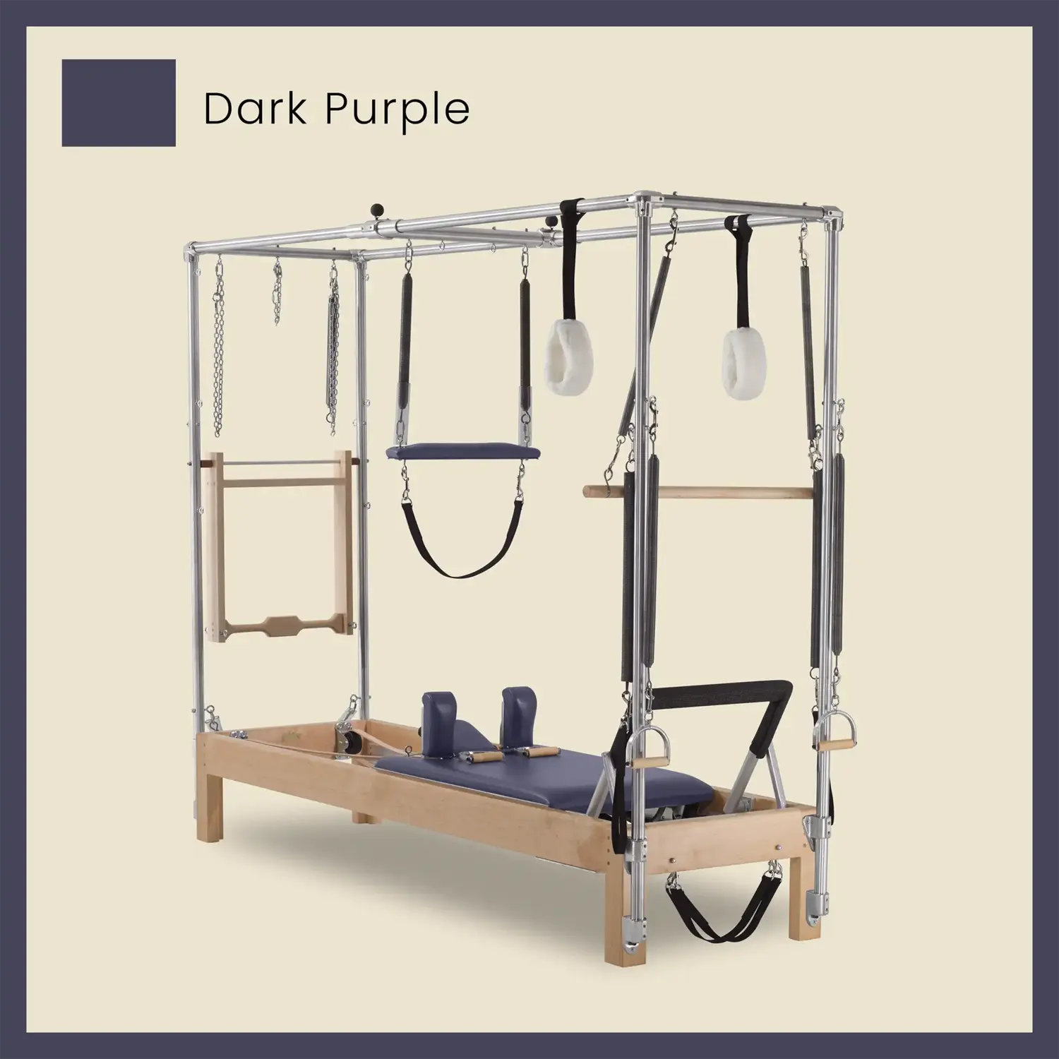 Dark purple wood Cadillac conversion Pilates reformer with full trapeze frame, springs, and straps.
