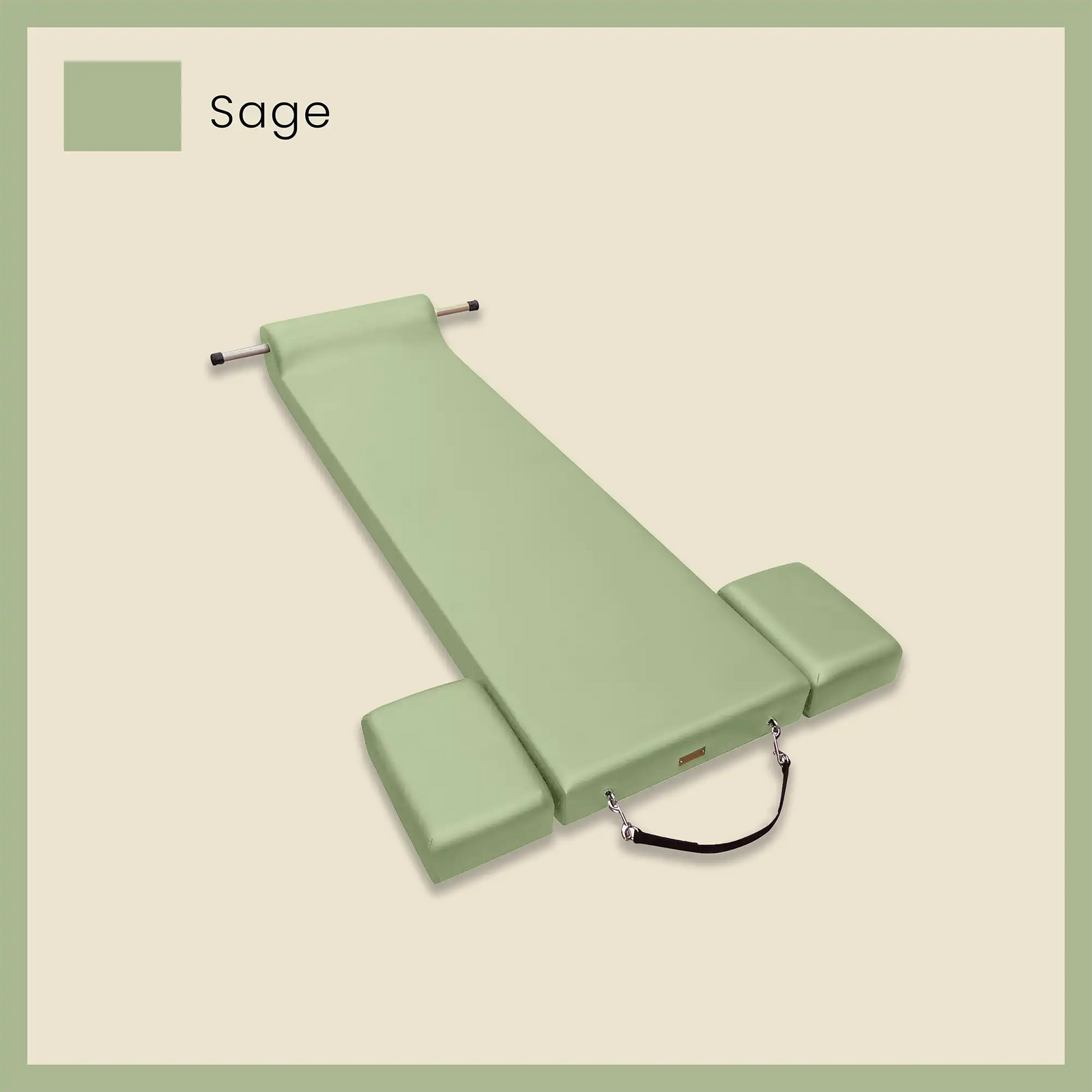 Green pilates mat with attached foot strap and blocks displayed in a sage color on a neutral background.