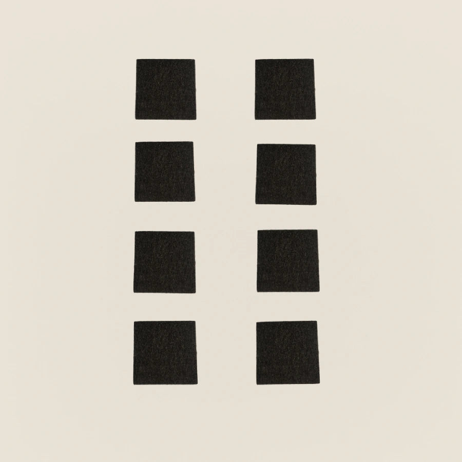 Set of eight black non-slip rubber pads for Gratz Pilates equipment feet.