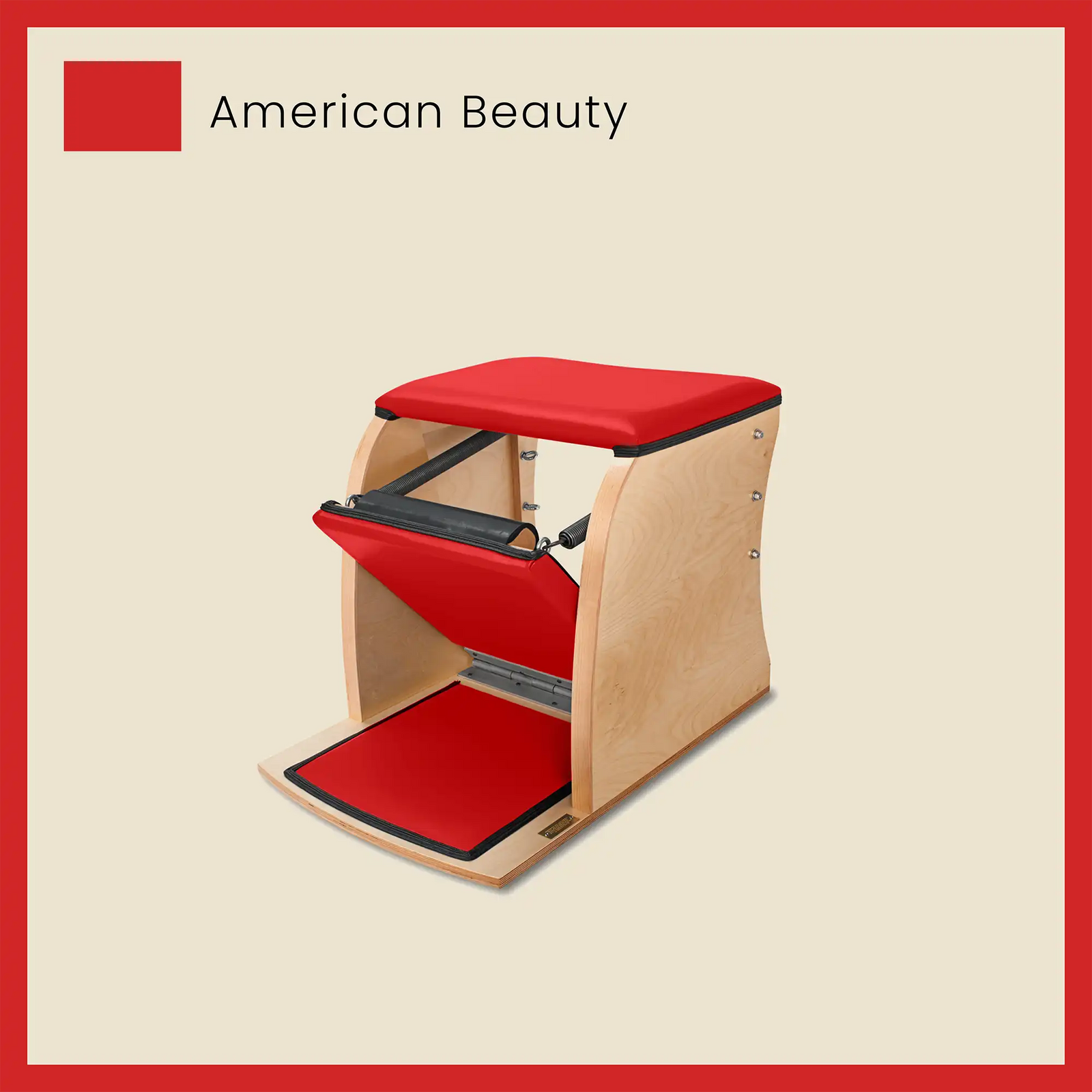 Red Wunda chair with bold American Beauty upholstery and maple wood base.