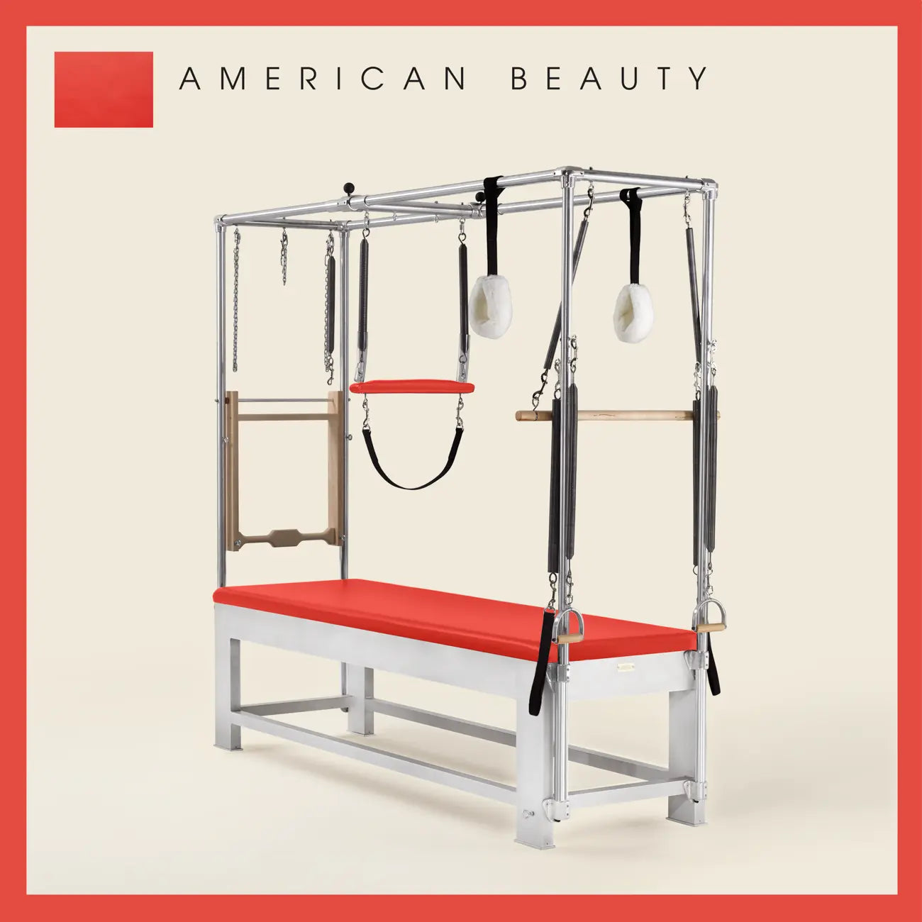 American Beauty color Trapeze Table with aluminum frame, adjustable bars, straps, and springs. Premium Pilates equipment against a beige background.