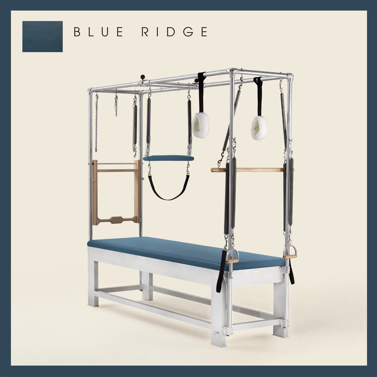 Blue Ridge color Trapeze Table with aluminum frame, adjustable bars, straps, and springs. Premium Pilates equipment against a beige background.