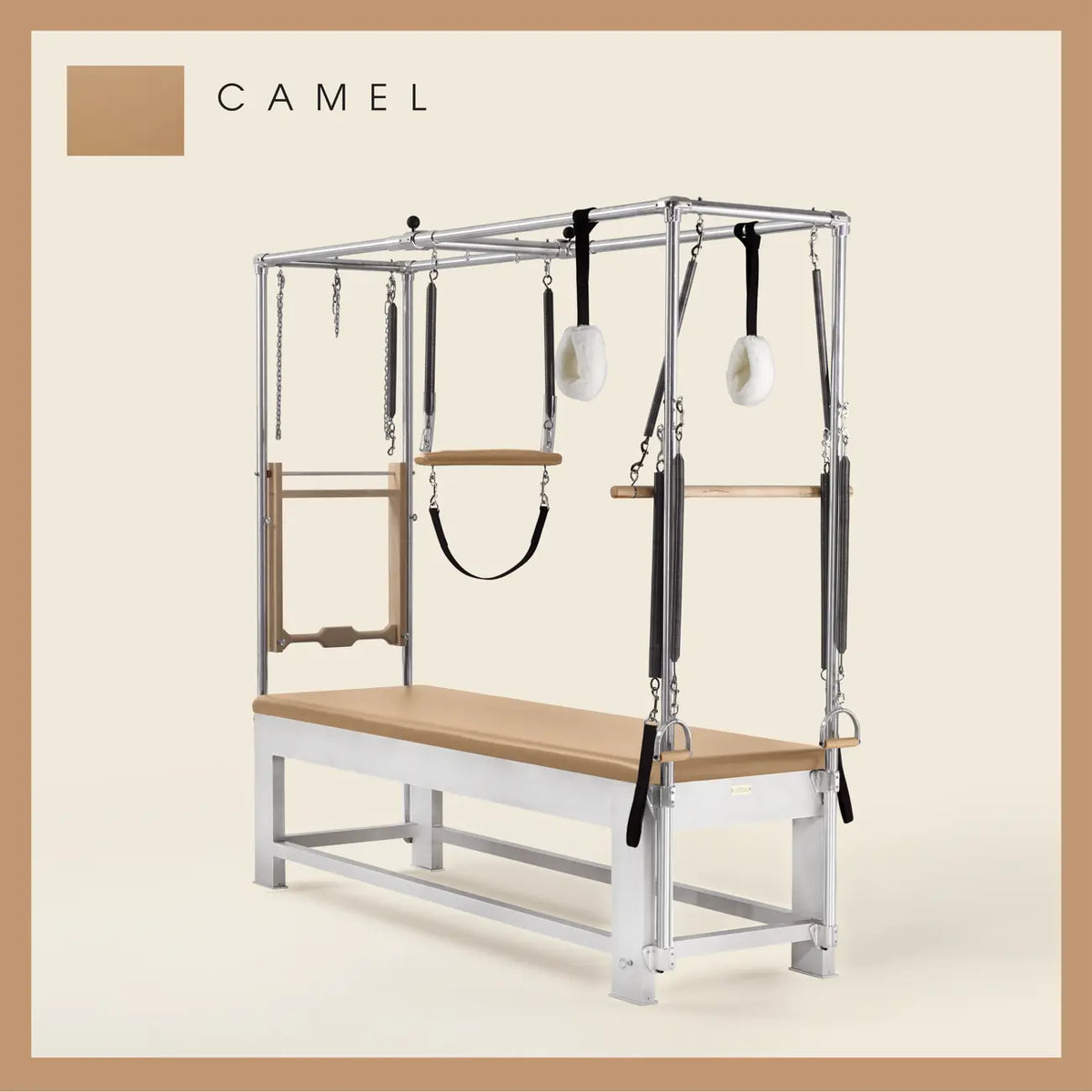 Camel color Trapeze Table with aluminum frame, adjustable bars, straps, and springs. Premium Pilates equipment against a beige background.