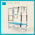 Capri Blue color Trapeze Table with aluminum frame, adjustable bars, straps, and springs. Premium Pilates equipment against a beige background.