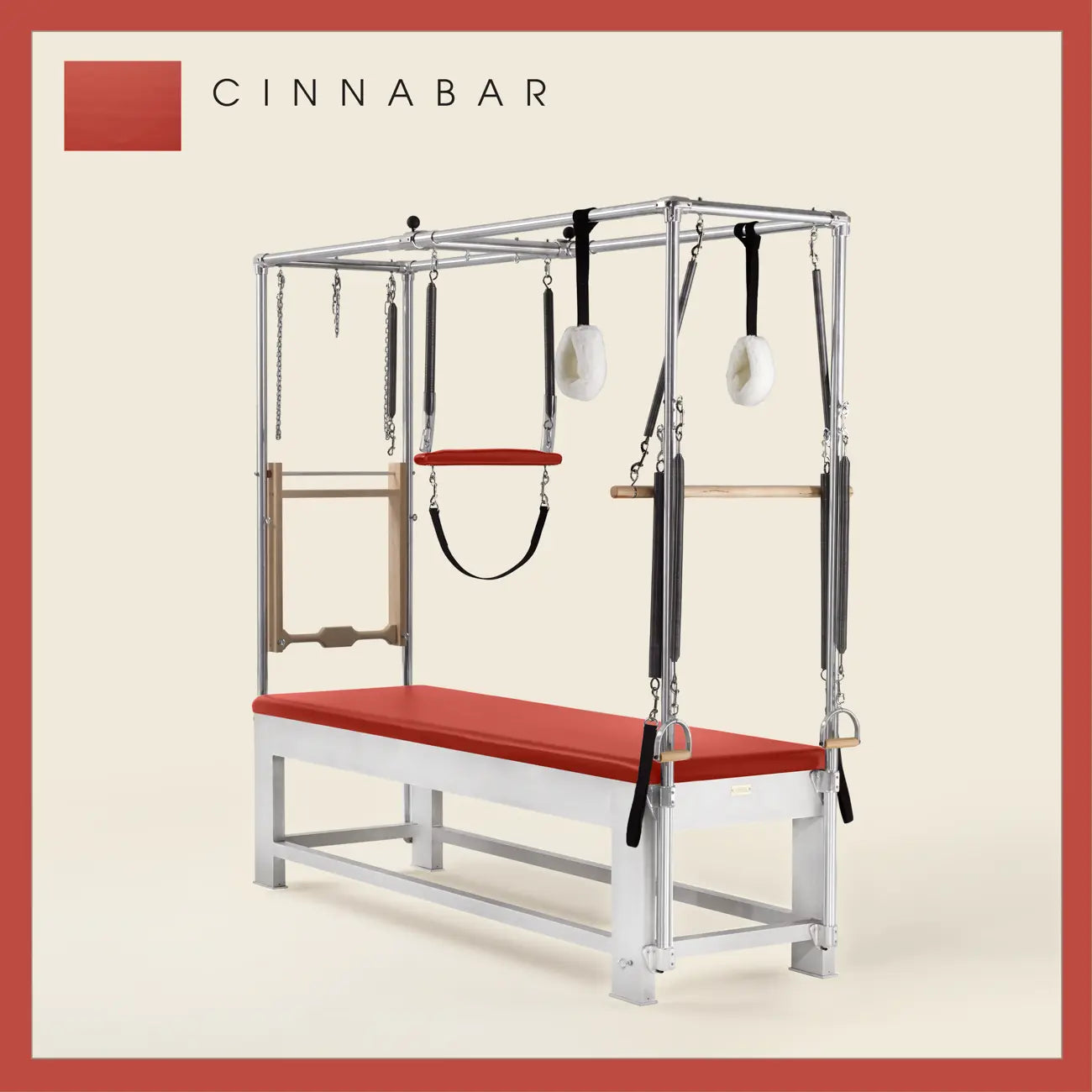 Cinnabar color Trapeze Table with aluminum frame, adjustable bars, straps, and springs. Premium Pilates equipment against a beige background.