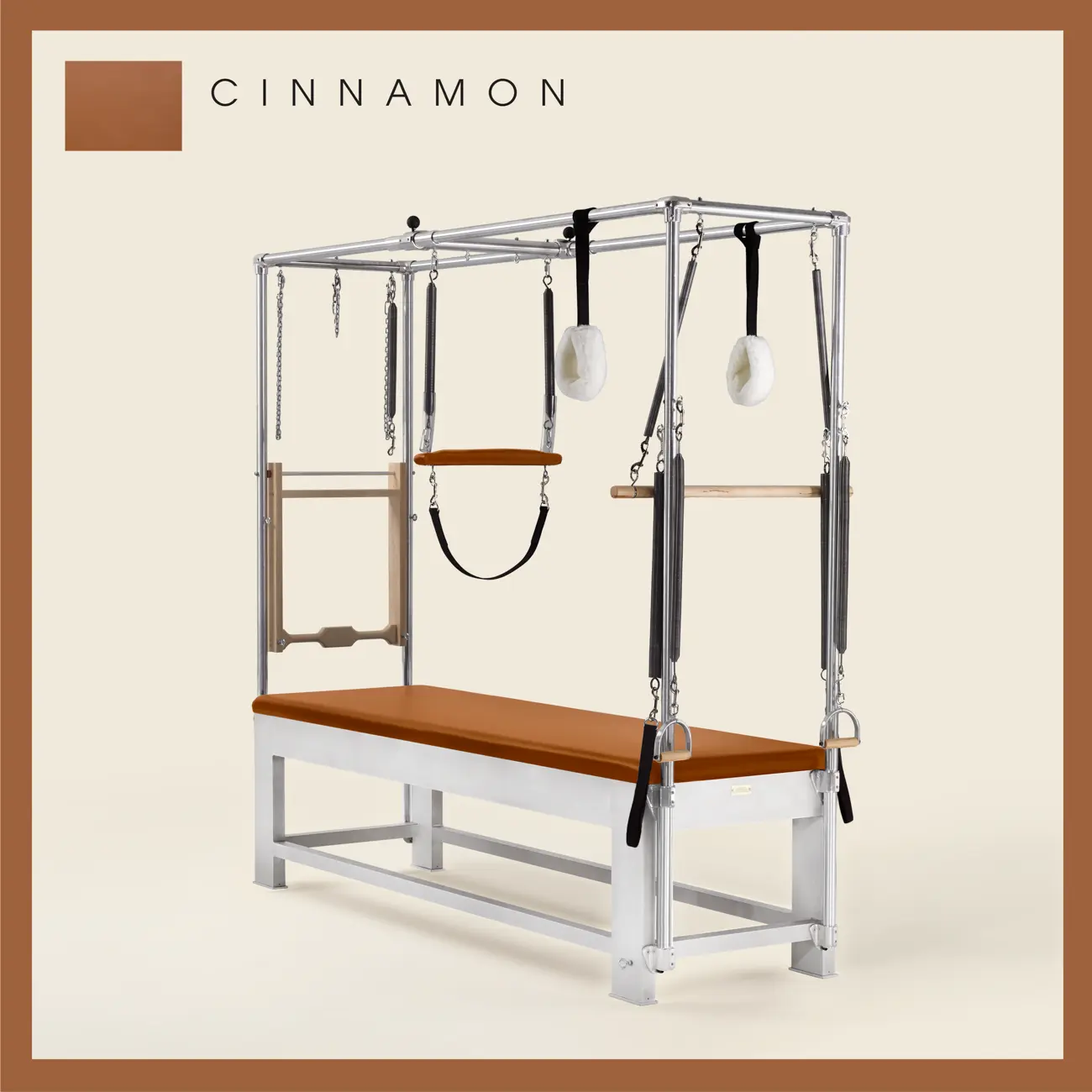 Cinnamon color Trapeze Table with aluminum frame, adjustable bars, straps, and springs. Premium Pilates equipment against a beige background.