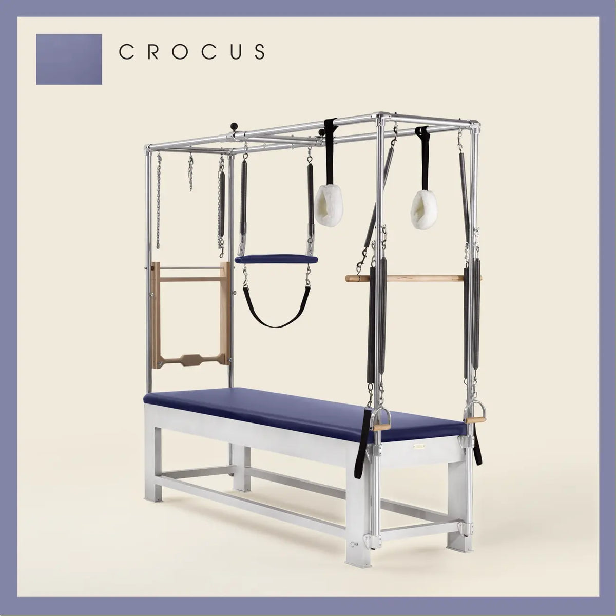 Crocus color Trapeze Table with aluminum frame, adjustable bars, straps, and springs. Premium Pilates equipment against a beige background.
