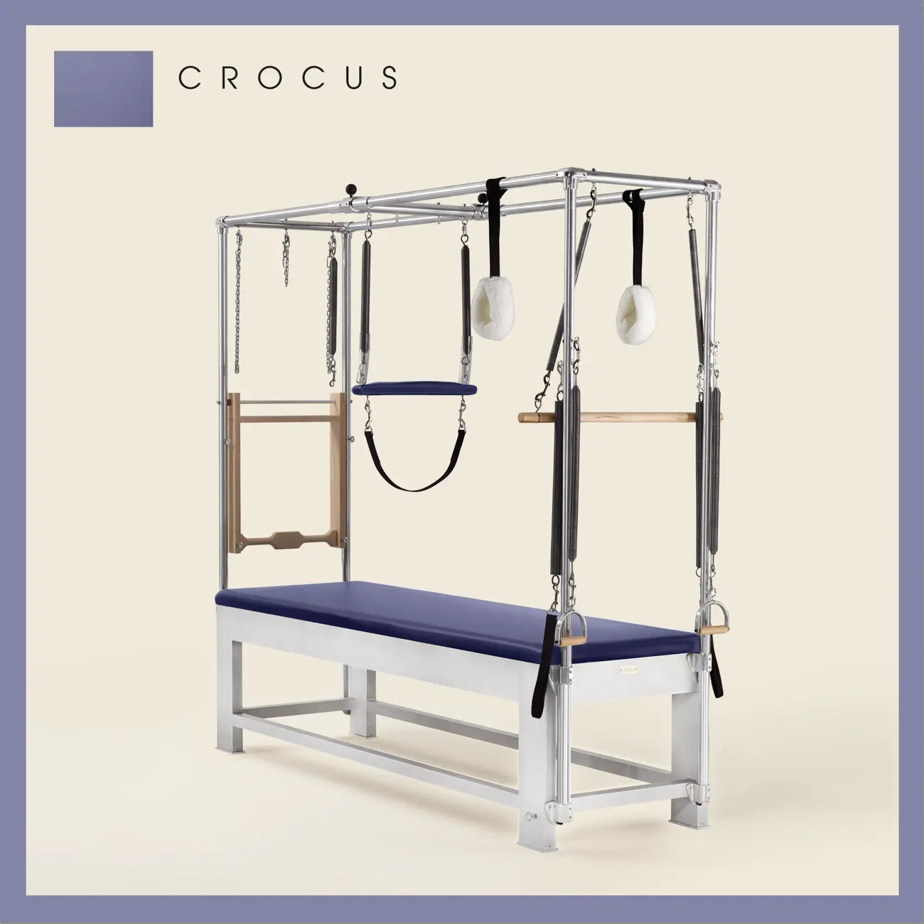 Crocus color Trapeze Table with aluminum frame, adjustable bars, straps, and springs. Premium Pilates equipment against a beige background.