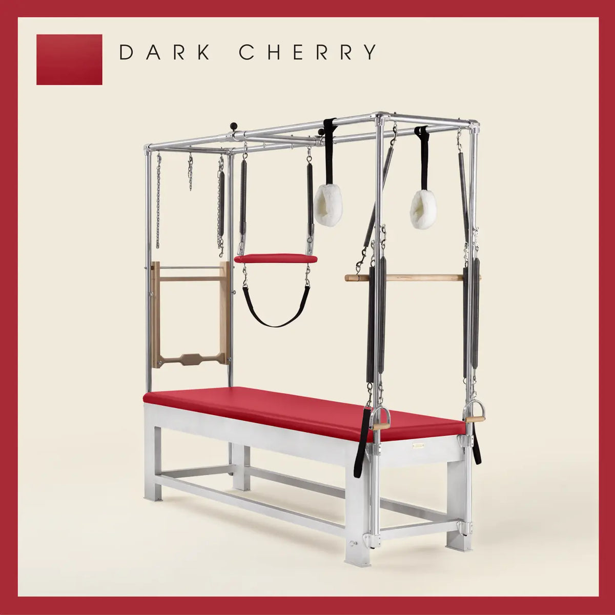 Dark Cherry color Trapeze Table with aluminum frame, adjustable bars, straps, and springs. Premium Pilates equipment against a beige background.