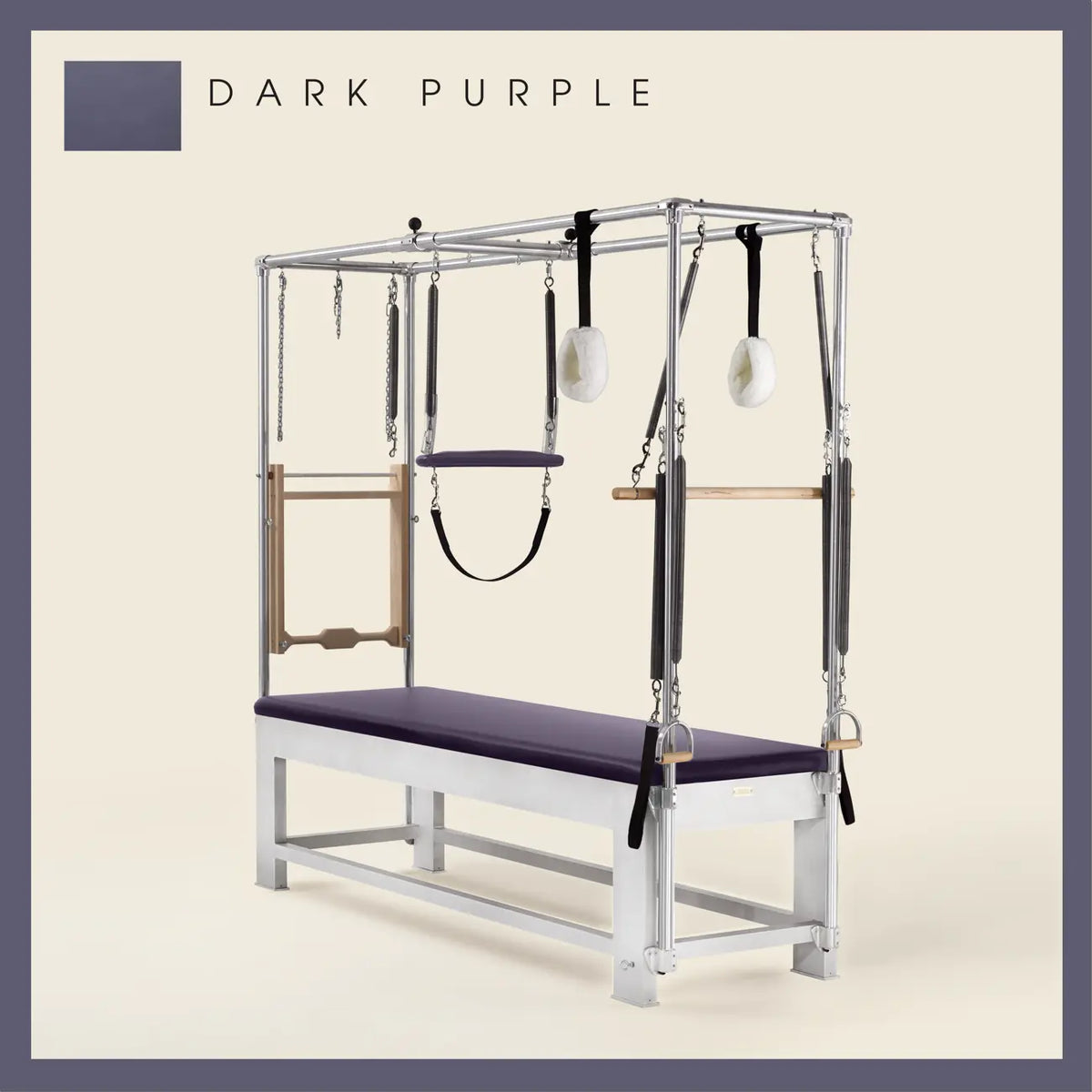 Dark Purple color Trapeze Table with aluminum frame, adjustable bars, straps, and springs. Premium Pilates equipment against a beige background.