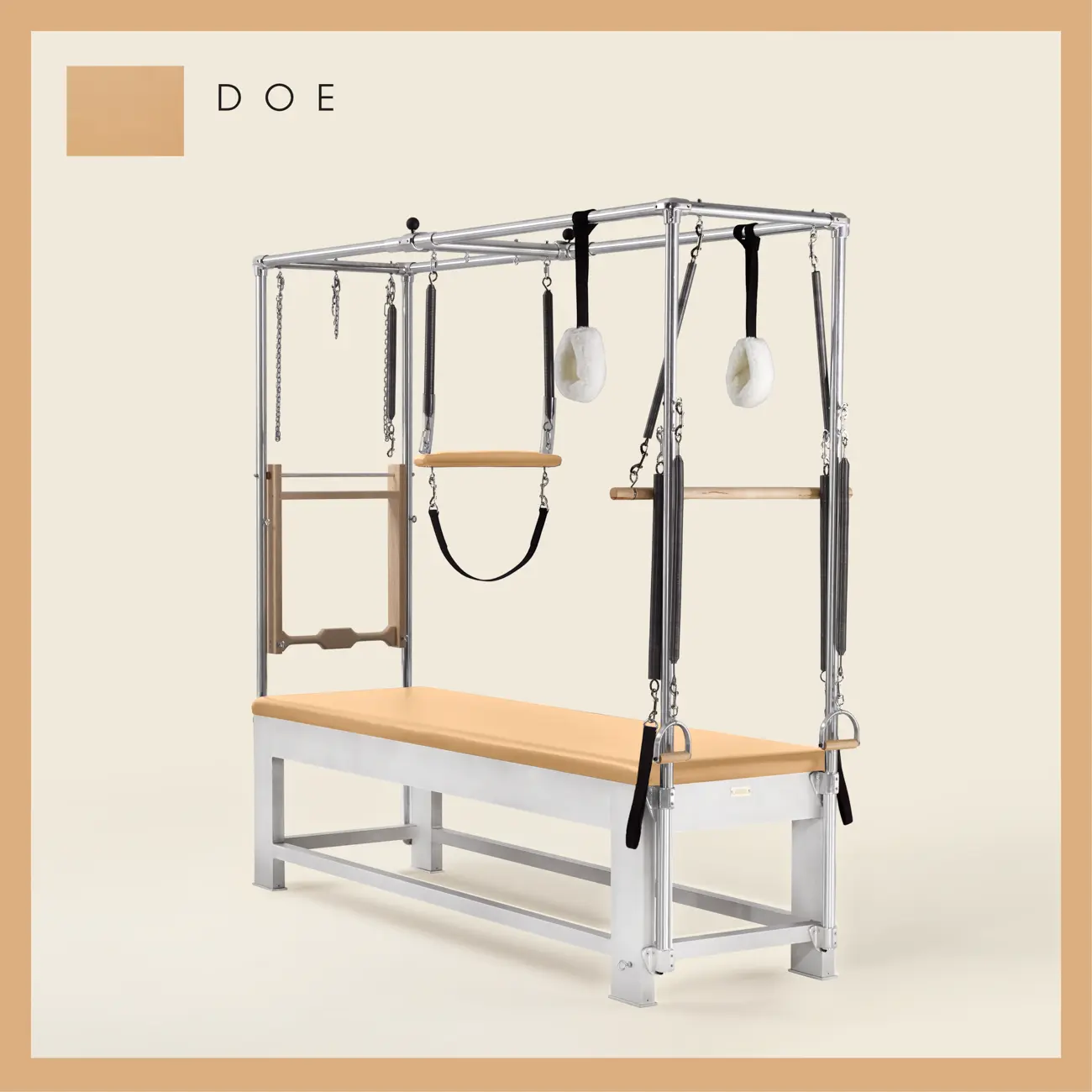 Doe color Trapeze Table with aluminum frame, adjustable bars, straps, and springs. Premium Pilates equipment against a beige background.