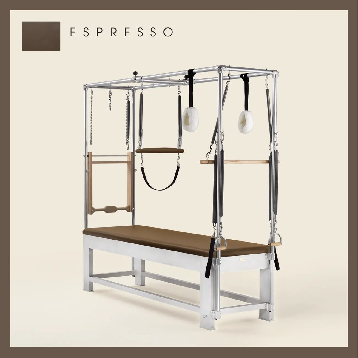 Espresso color Trapeze Table with aluminum frame, adjustable bars, straps, and springs. Premium Pilates equipment against a beige background.