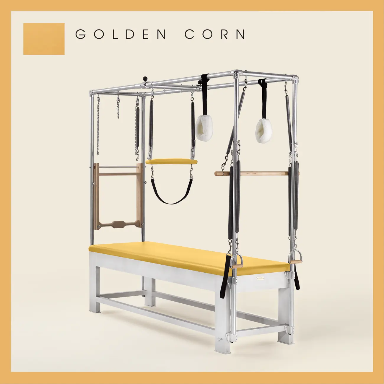 Golden Corn color Trapeze Table with aluminum frame, adjustable bars, straps, and springs. Premium Pilates equipment against a beige background.
