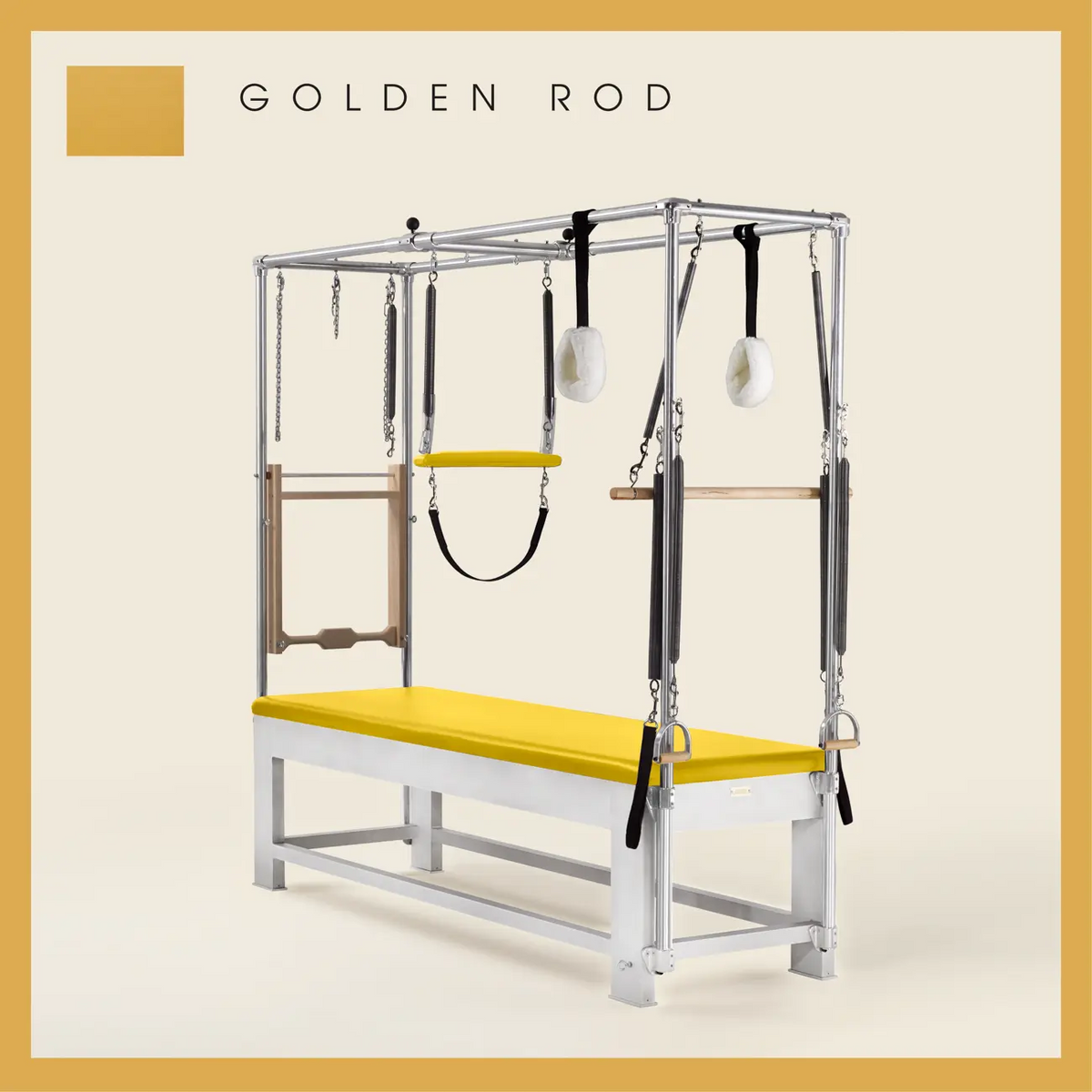 Golden Rod color Trapeze Table with aluminum frame, adjustable bars, straps, and springs. Premium Pilates equipment against a beige background.
