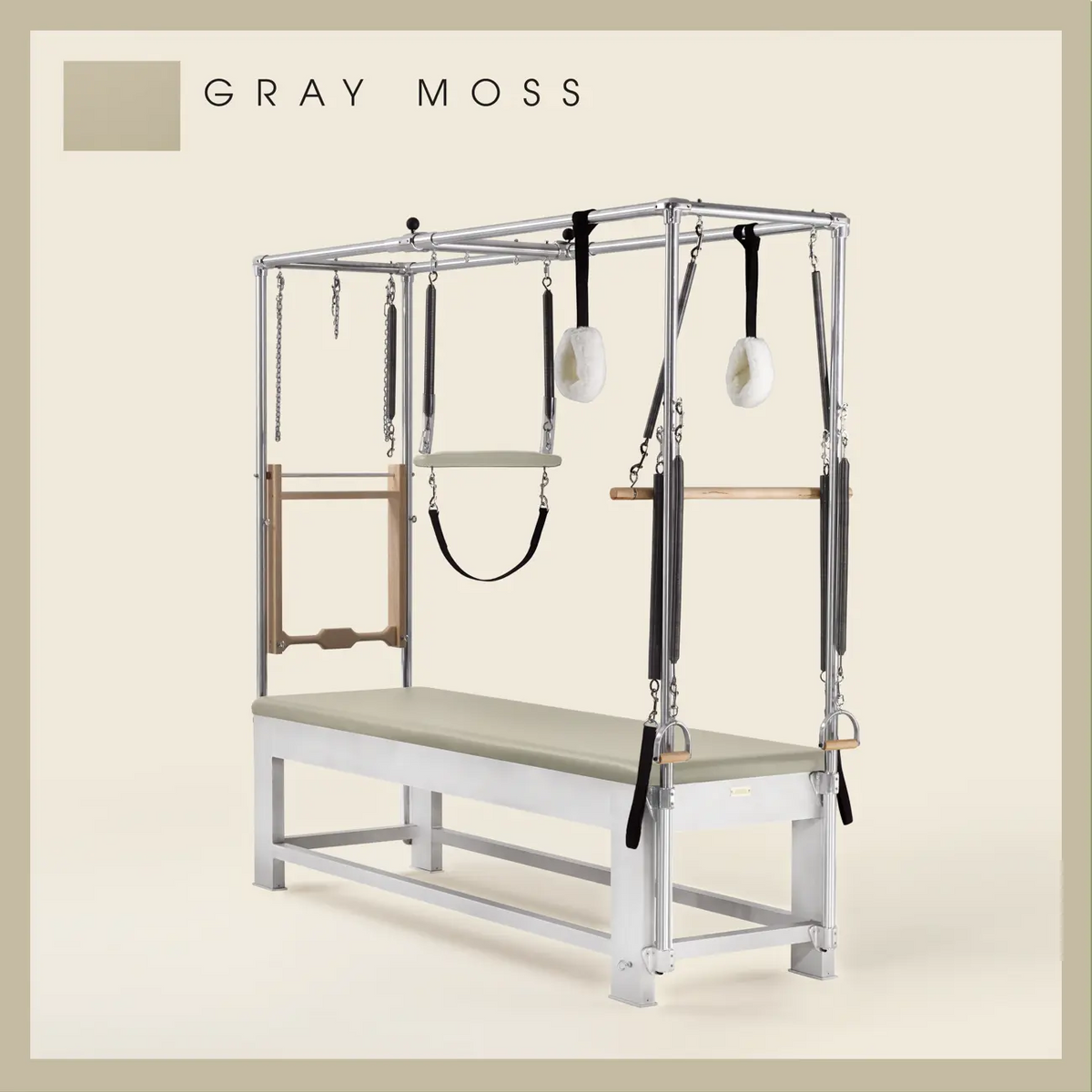 Gray moss color Trapeze Table with aluminum frame, adjustable bars, straps, and springs. Premium Pilates equipment against a beige background.