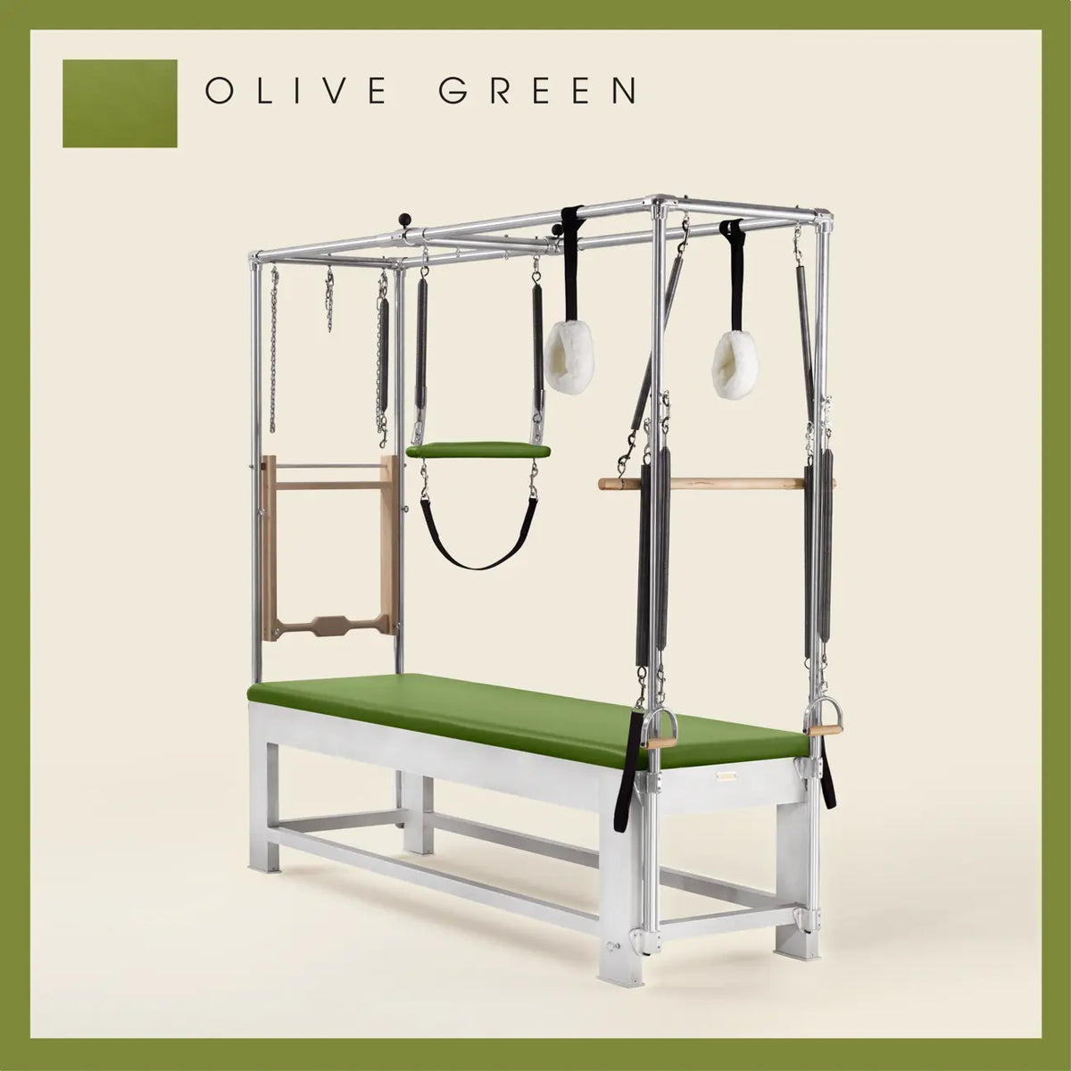 Olive Green color Trapeze Table with aluminum frame, adjustable bars, straps, and springs. Premium Pilates equipment against a beige background.