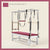 Raspberry color Trapeze Table with aluminum frame, adjustable bars, straps, and springs. Premium Pilates equipment against a beige background.