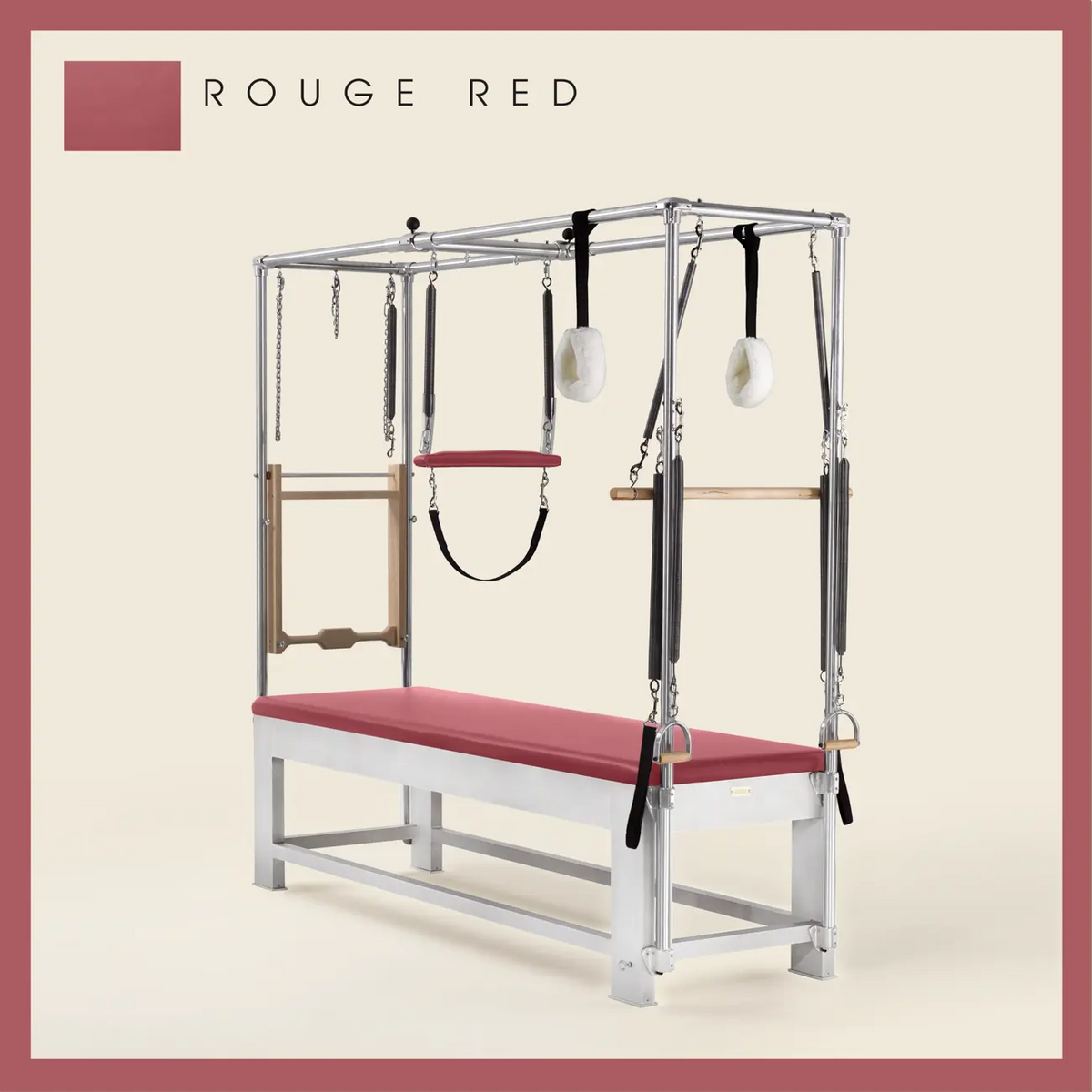 Rouge red color Trapeze Table with aluminum frame, adjustable bars, straps, and springs. Premium Pilates equipment against a beige background.