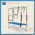 Space Blue color Trapeze Table with aluminum frame, adjustable bars, straps, and springs. Premium Pilates equipment against a beige background.