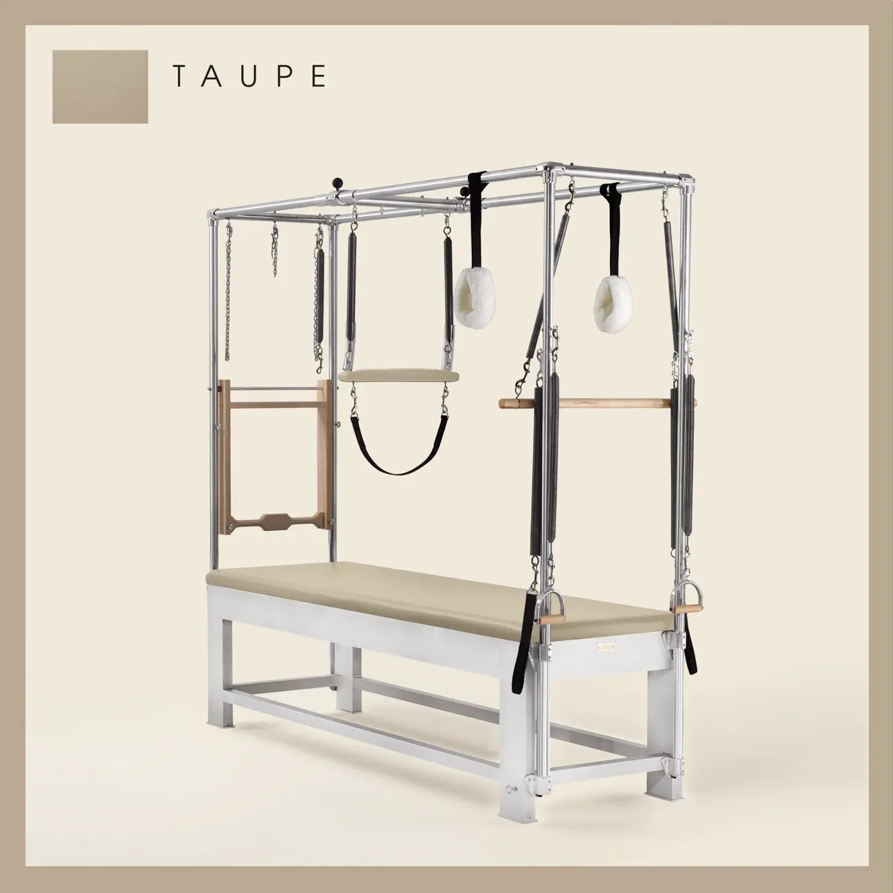 Taupe color Trapeze Table with aluminum frame, adjustable bars, straps, and springs. Premium Pilates equipment against a beige background.