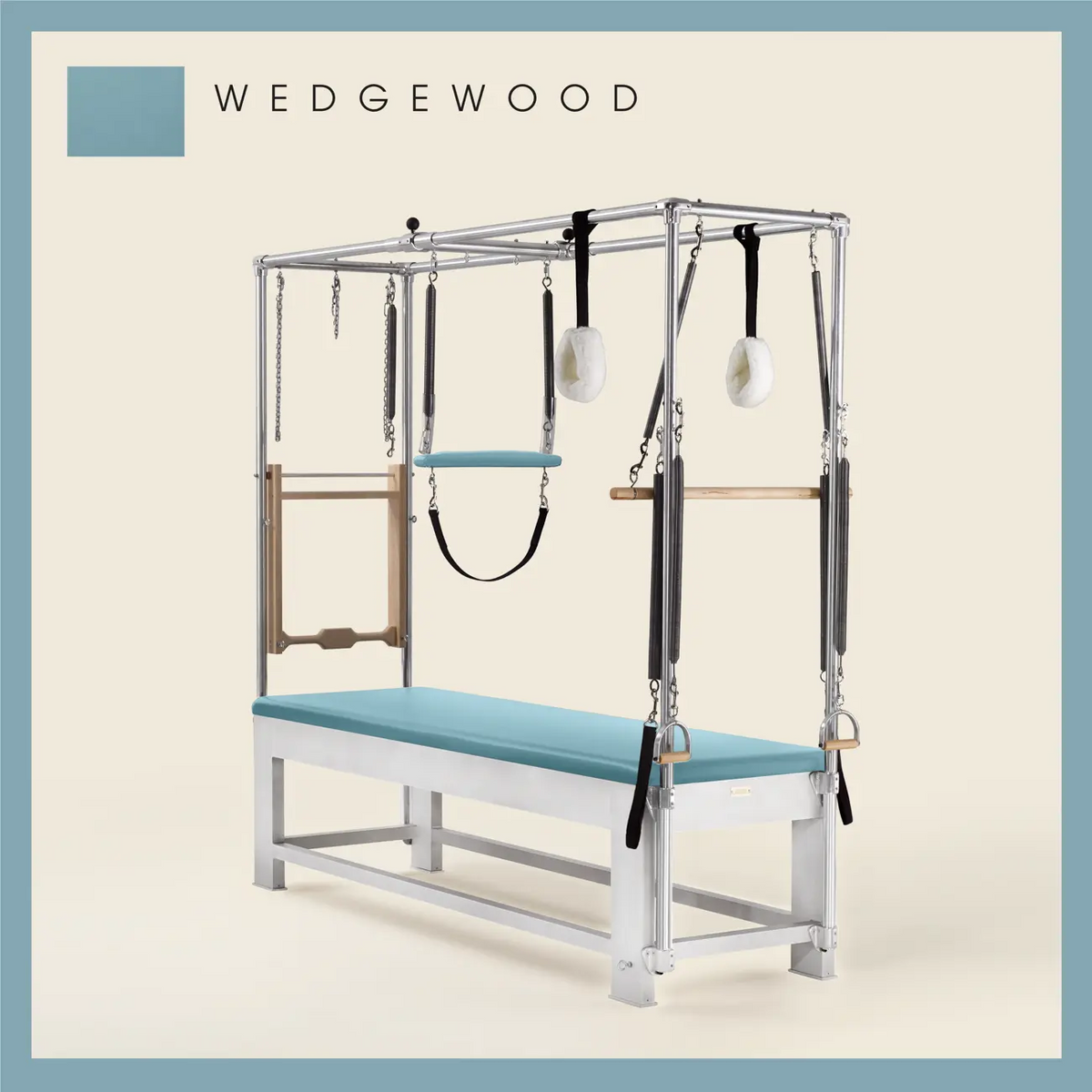 Wedgewood color Trapeze Table with aluminum frame, adjustable bars, straps, and springs. Premium Pilates equipment against a beige background.