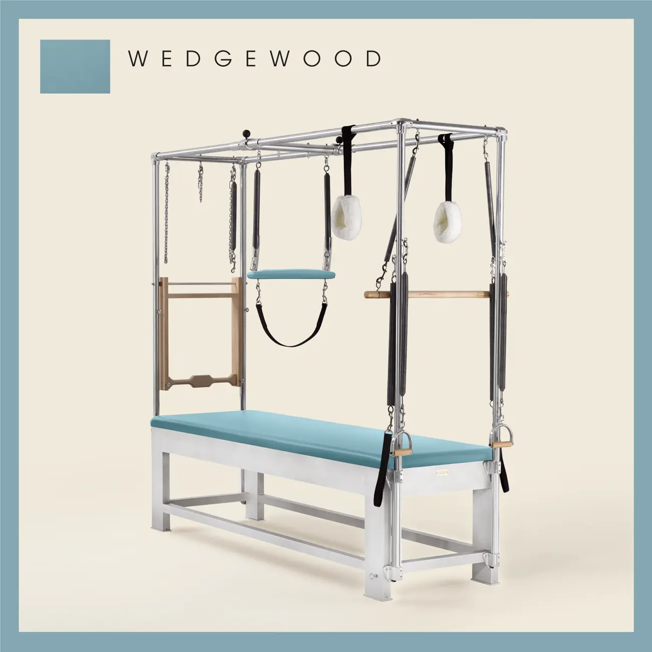 Wedgewood color Trapeze Table with aluminum frame, adjustable bars, straps, and springs. Premium Pilates equipment against a beige background.