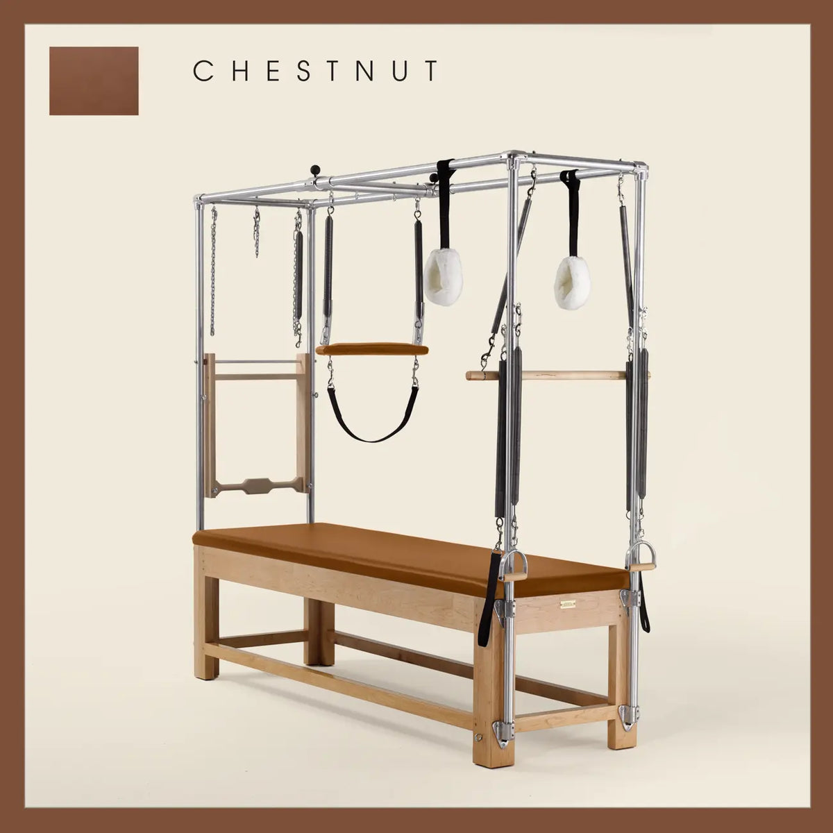 Chestnut color Pilates Cadillac with maple wood frame, adjustable bars, straps, and springs. Premium Pilates equipment against a beige background.