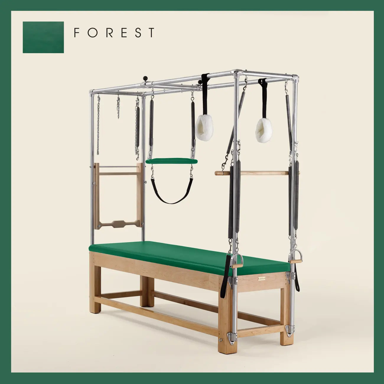 Forest color Pilates Cadillac with maple wood frame, adjustable bars, straps, and springs. Premium Pilates equipment against a beige background.