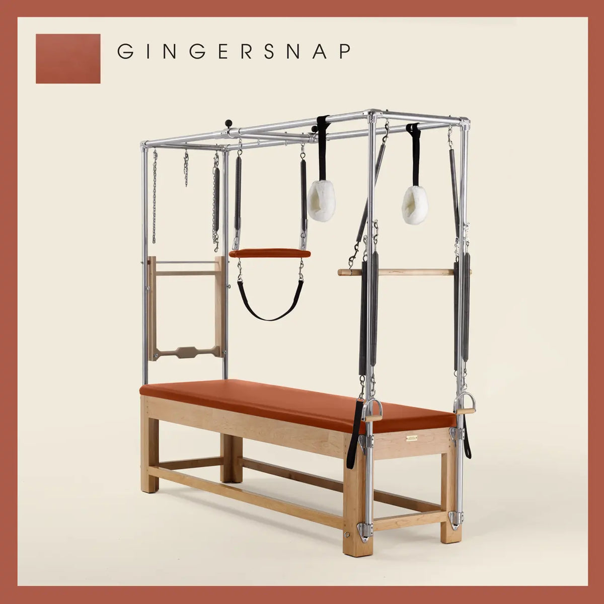 Gingersnap color Pilates Cadillac with maple wood frame, adjustable bars, straps, and springs. Premium Pilates equipment against a beige background.