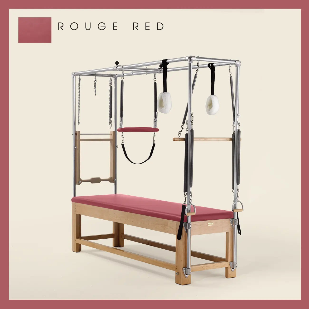 Rouge Red Pilates Cadillac with maple wood frame, adjustable bars, straps, and springs. Premium Pilates equipment against a beige background.