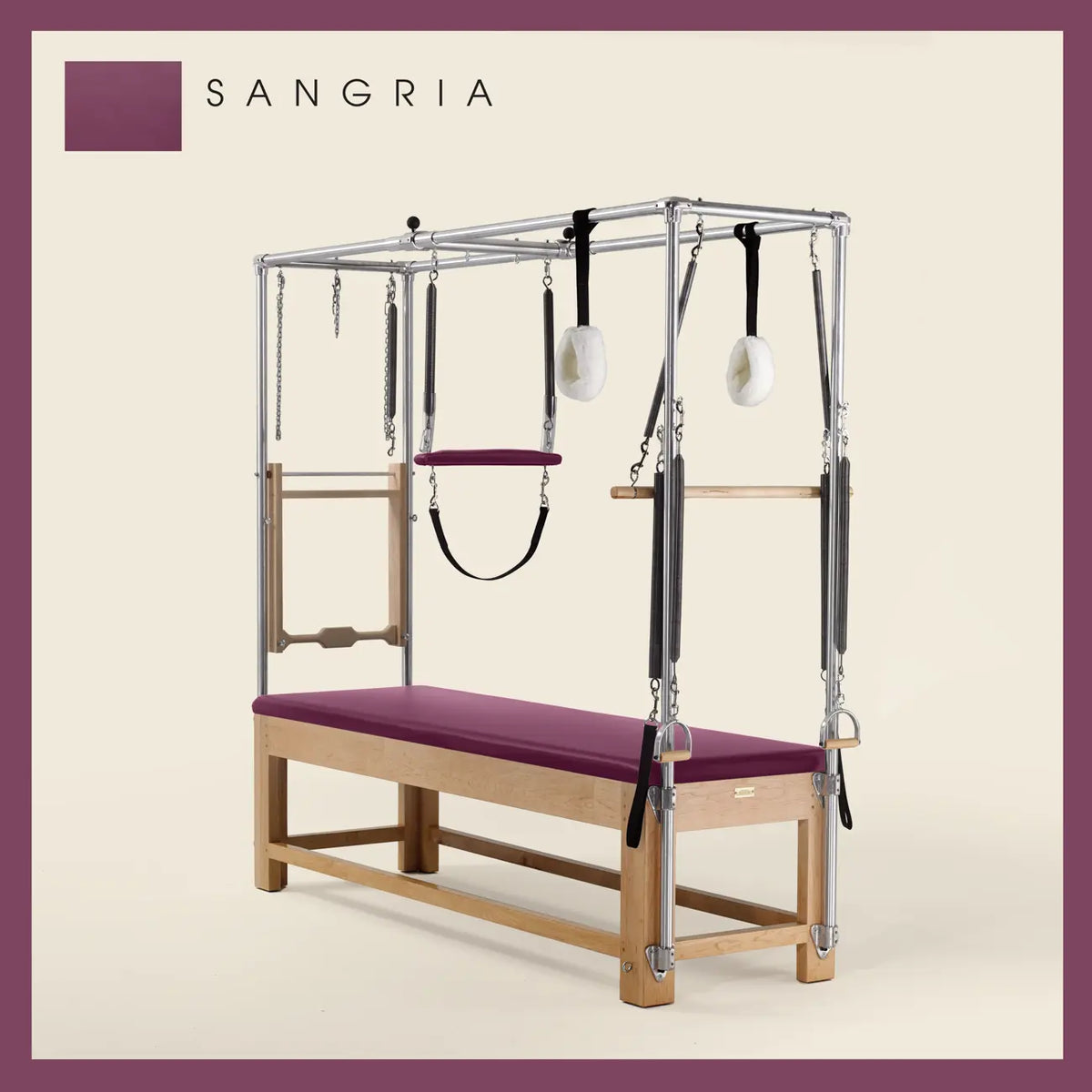 Sangria Pilates Cadillac with maple wood frame, adjustable bars, straps, and springs. Premium Pilates equipment against a beige background.