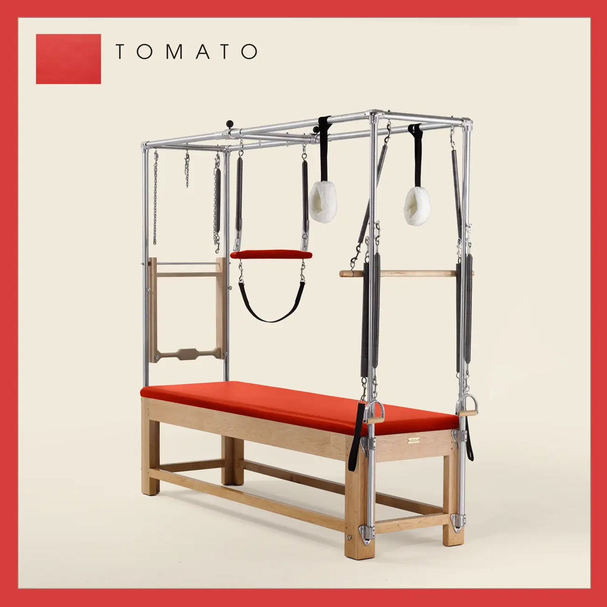 Tomatoe Pilates Cadillac with maple wood frame, adjustable bars, straps, and springs. Premium Pilates equipment against a beige background.