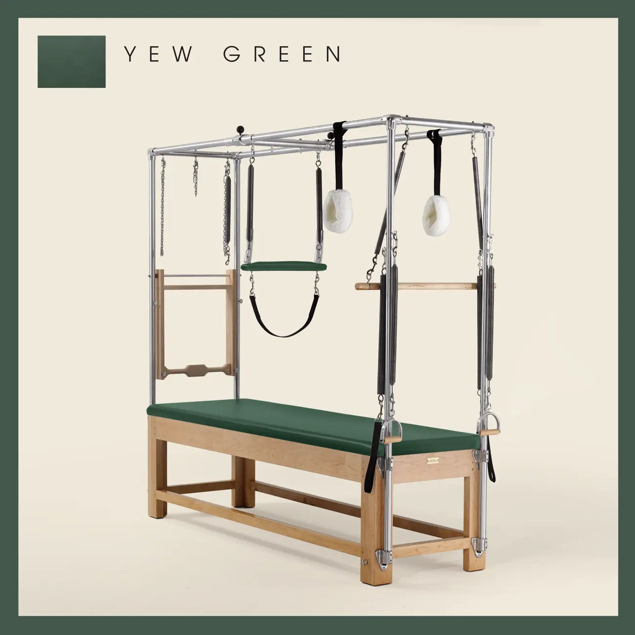 Yew Green Pilates Cadillac with maple wood frame, adjustable bars, straps, and springs. Premium Pilates equipment against a beige background.