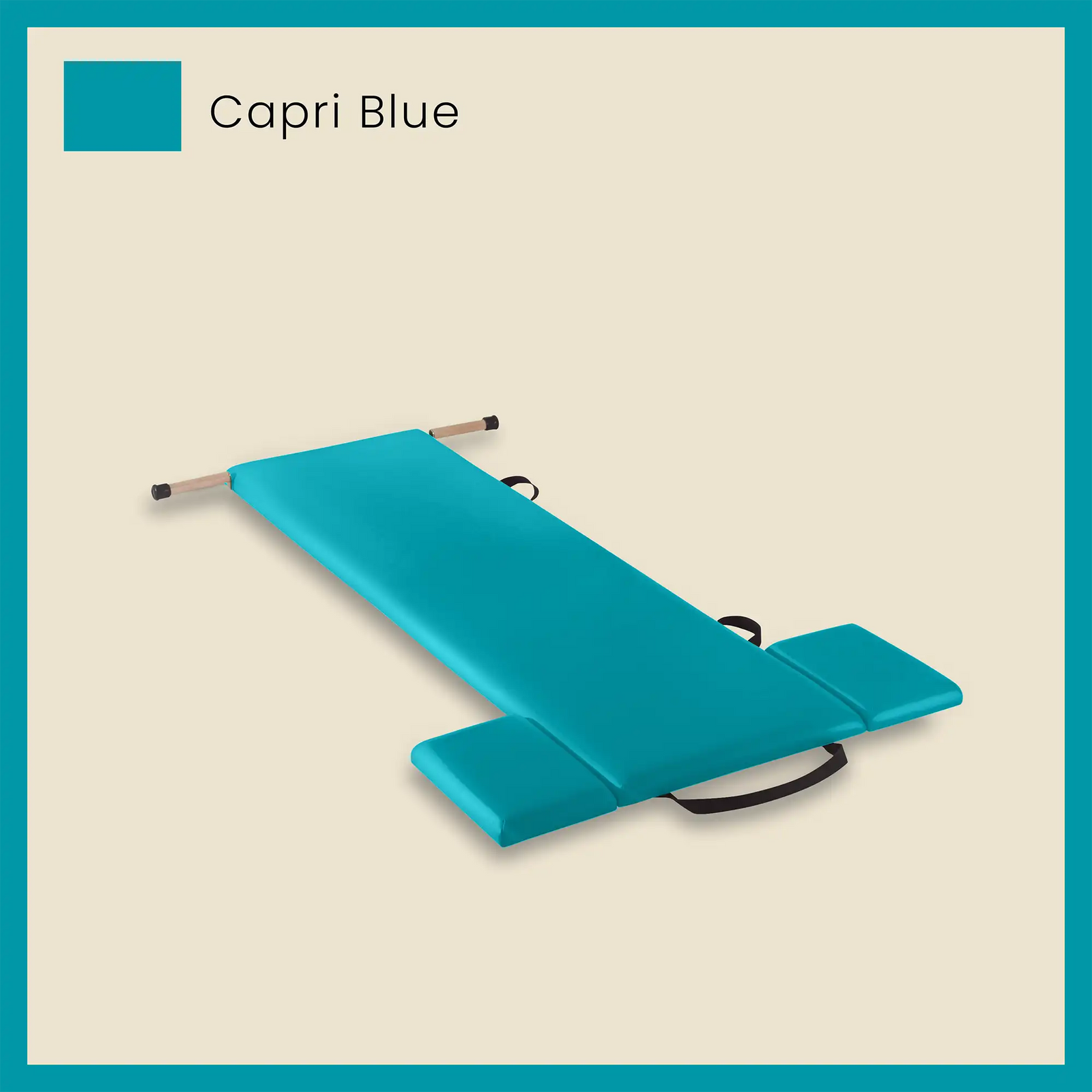 Blue pilates mat in Capri Blue color with foot strap and side cushions on a neutral beige background.