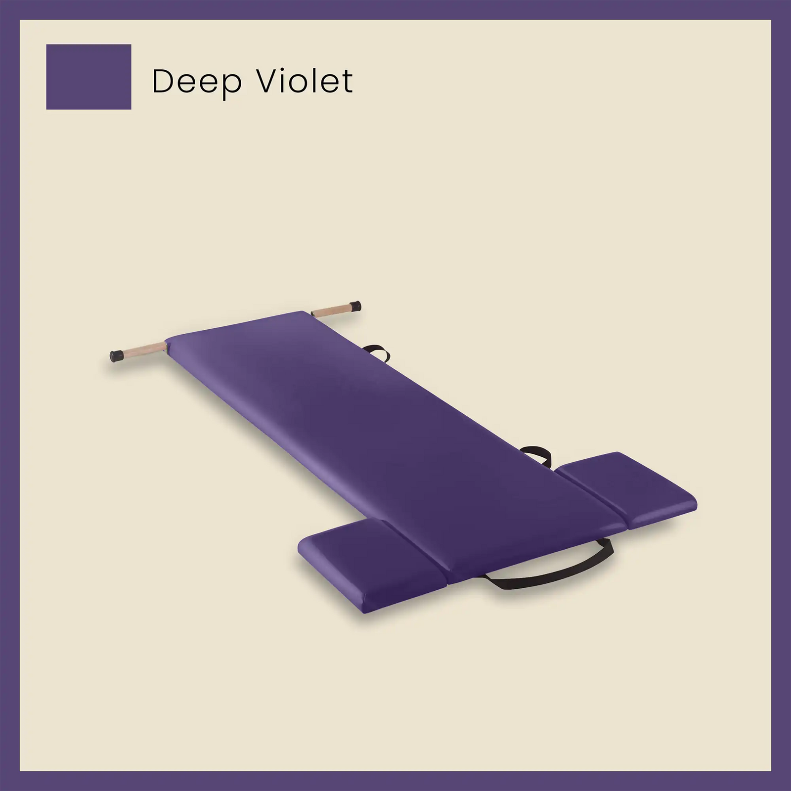 Purple thick pilates mat in deep violet color with foot strap and side cushions on a beige background.
