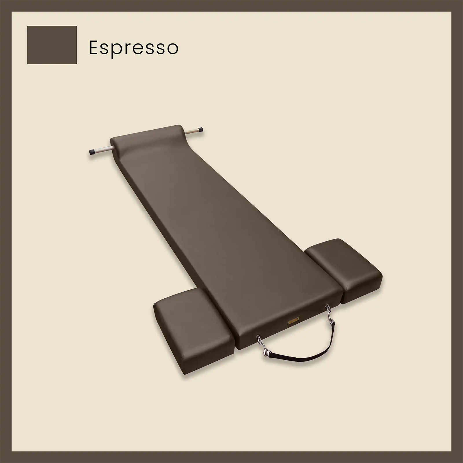 Dark brown pilates mat in espresso color with side cushions and foot strap on a beige background.