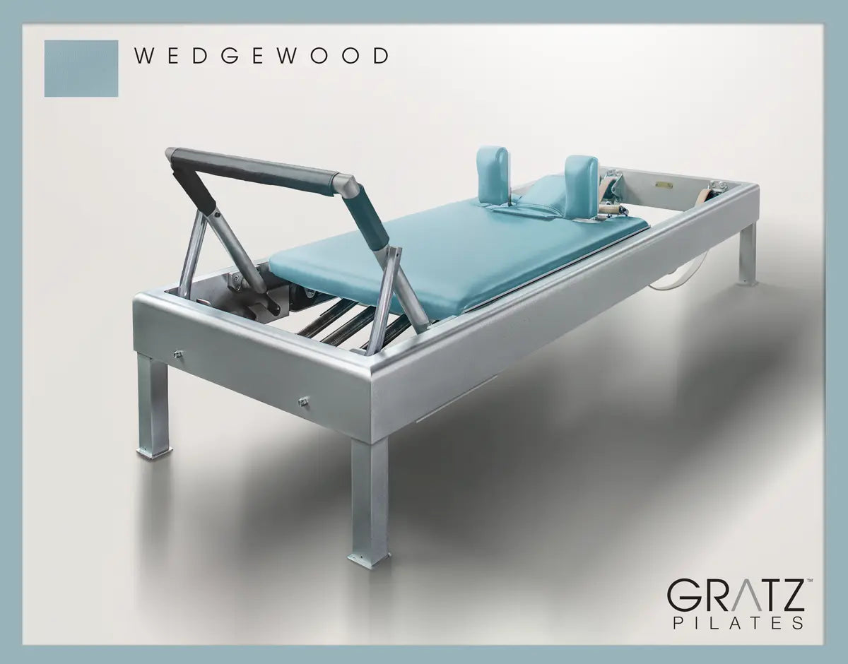 Gratz Pilates Aluminum Archive Reformer Padded Carriage in 'Wedgewood' color.  Soft beige background. 