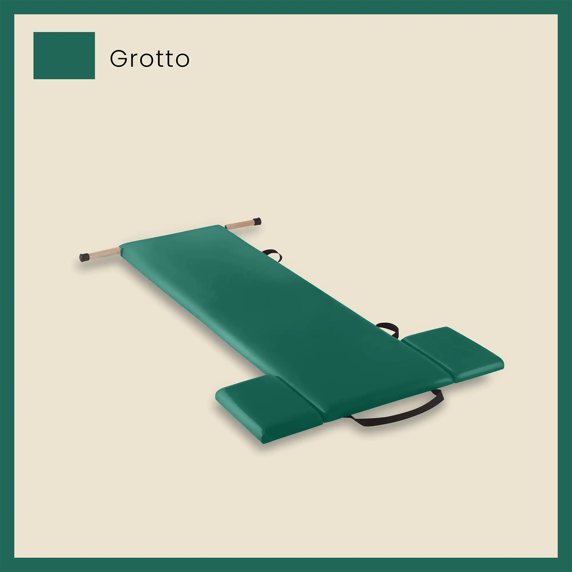 Green pilates mat in grotto color with foot strap and side cushions on a light beige background.