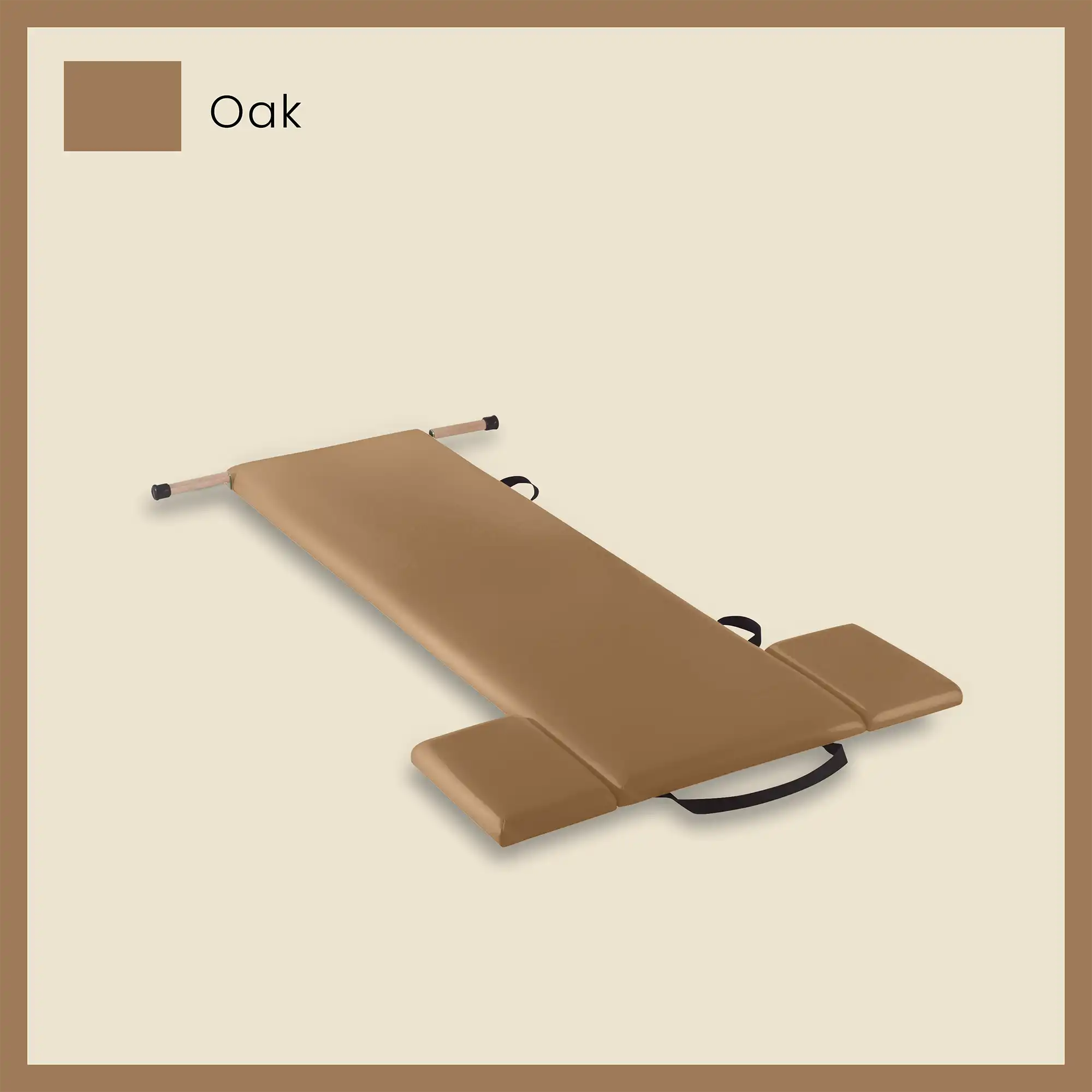 Pilates mat in oak color with foot strap and side cushions on a light beige background.