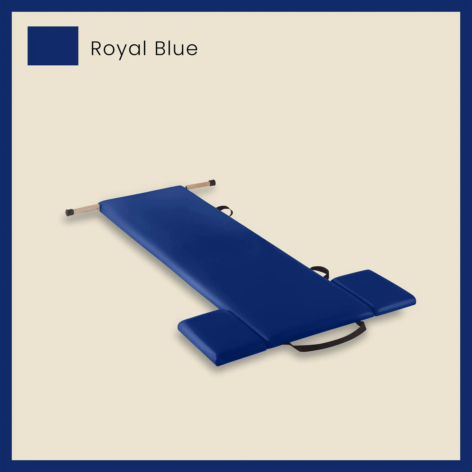 Blue pilates mat in royal blue color with foot strap and side cushions on a neutral beige background.